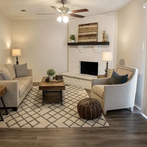 a living room with furniture and a fireplace