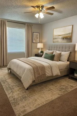 a bedroom with a large bed and a chandelier