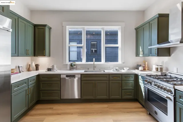a kitchen with a sink stove and cabinets