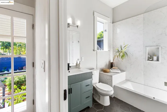 a bathroom with a toilet a sink and a window