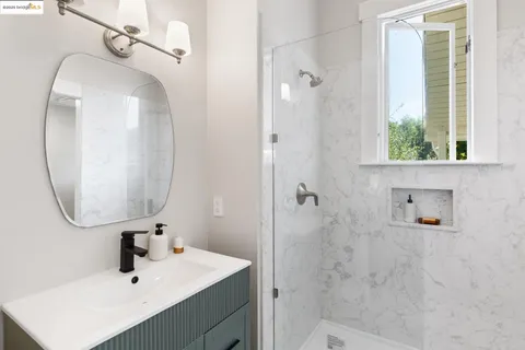 a bathroom with a sink a mirror and shower