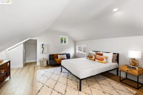 a bedroom with furniture and a wooden floor