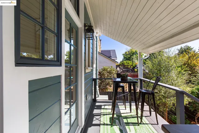 a view of a patio with table and chairs and wooden floor