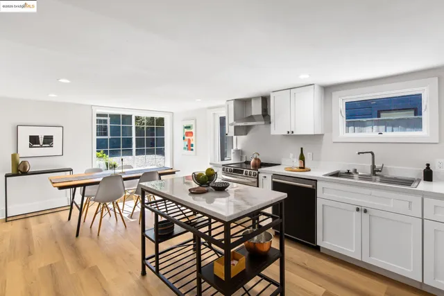 a kitchen with a stove a refrigerator and a dining table