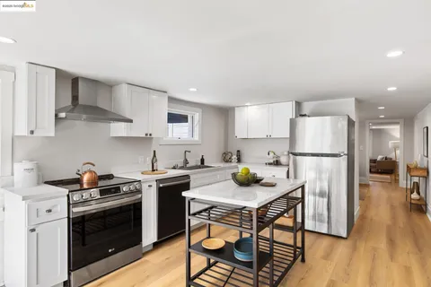 a view of a dining room with a table and chairs