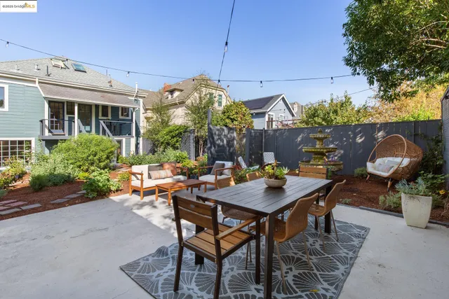 a view of a backyard with a table and chairs