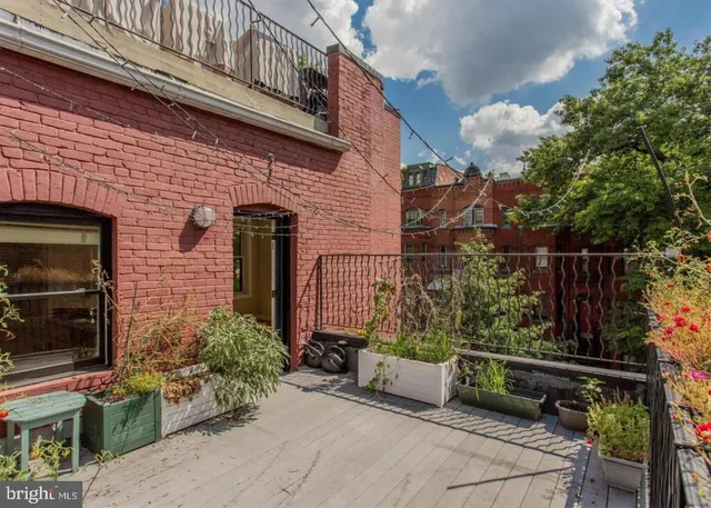 a view of a chair and table in the backyard