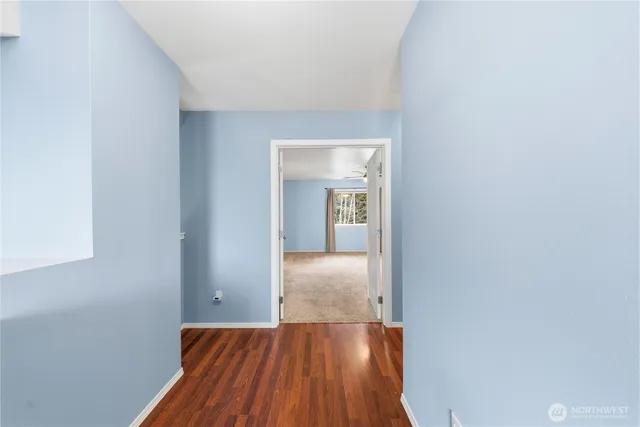 a view of hallway with wooden floor