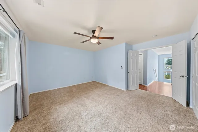 a view of a livingroom with a ceiling fan and a window