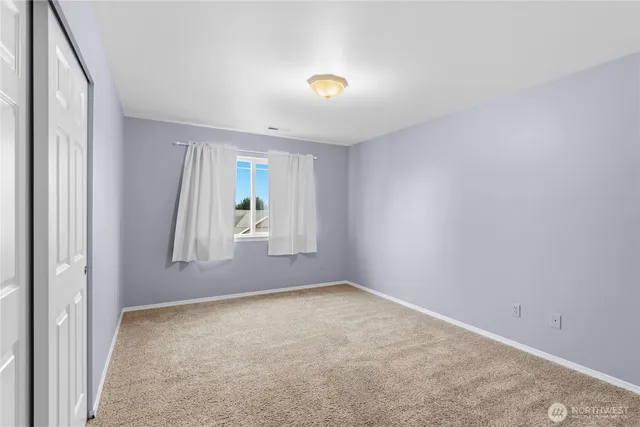 an empty room with windows and entrance