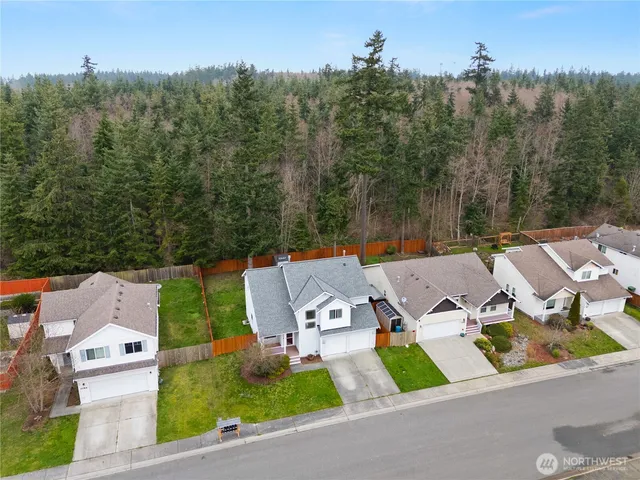 an aerial view of a house with garden space and street view
