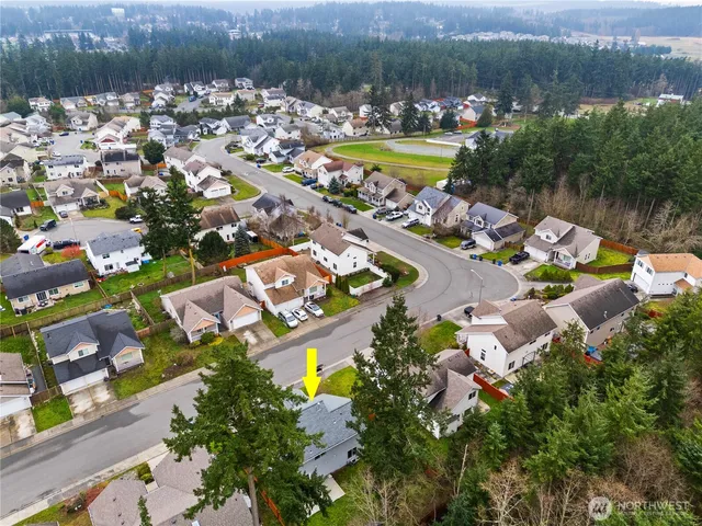an aerial view of a house with a lake view