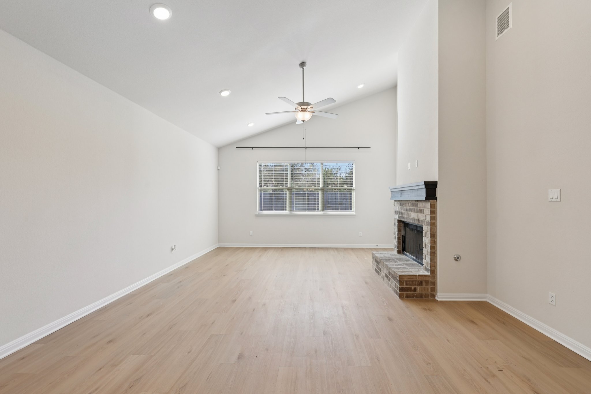 308 Castlefields Street Hutto, TX 78634 - Photo 13 of 31 wooden floor in an empty room with a window