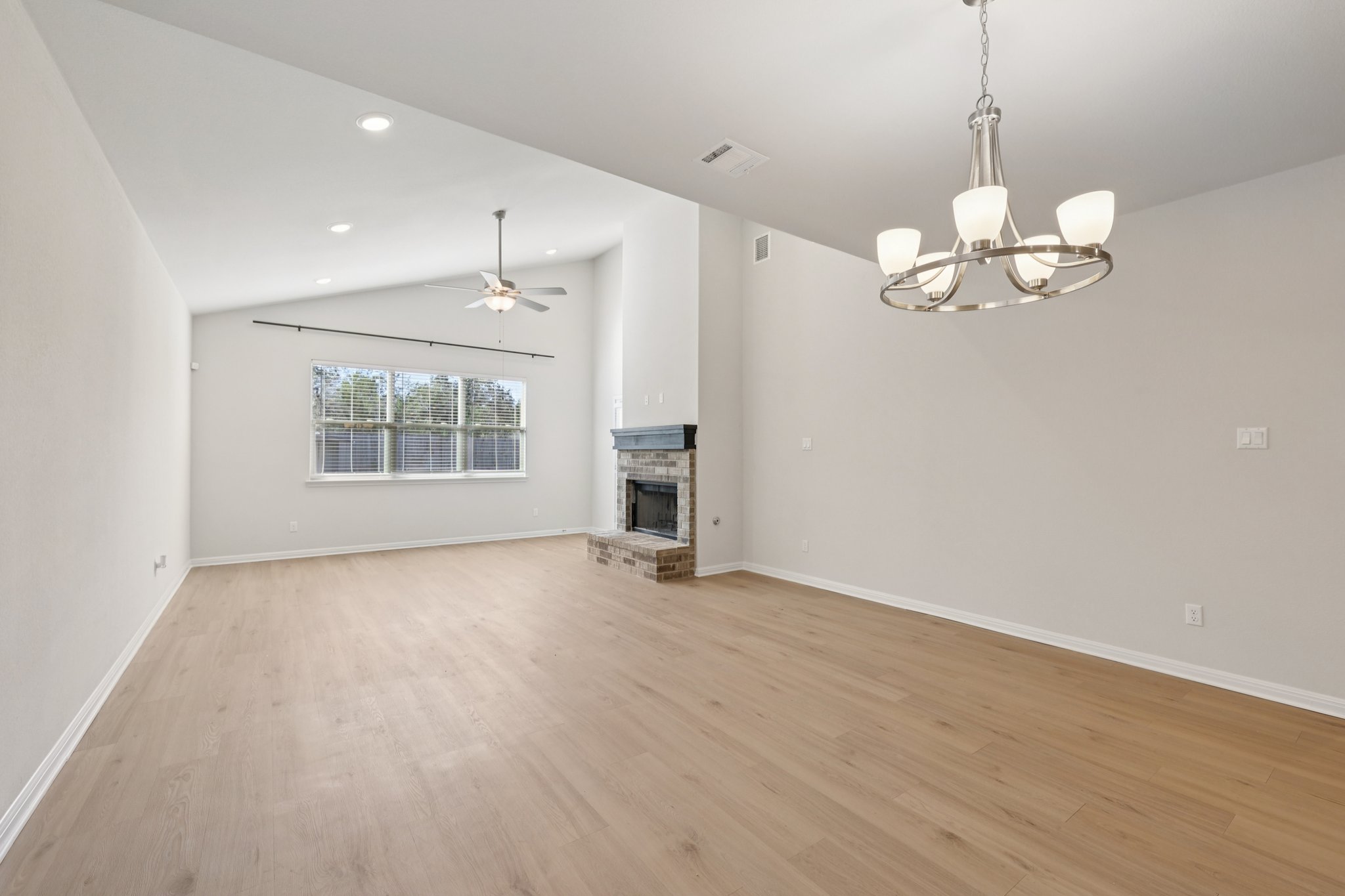 308 Castlefields Street Hutto, TX 78634 - Photo 14 of 31 a view of an empty room with a window and wooden floor