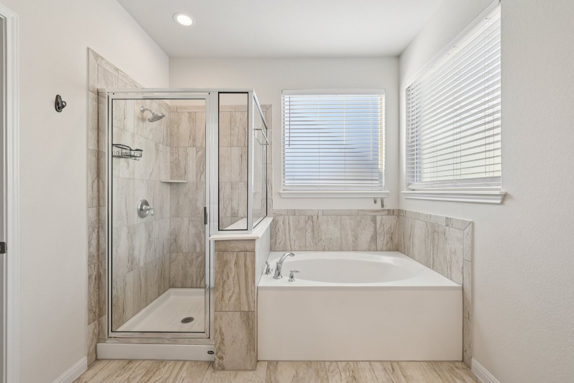 308 Castlefields Street Hutto, TX 78634 - Photo 17 of 31 a white bath tub sitting next to a shower