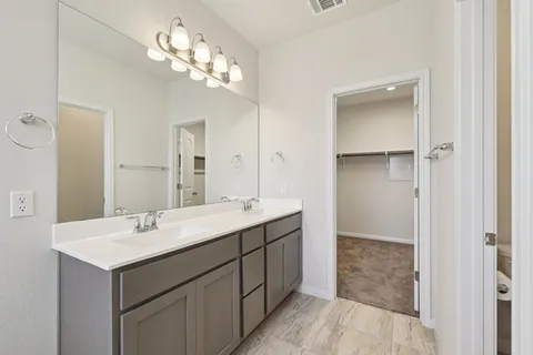 a bathroom with a sink a light fixture and a mirror