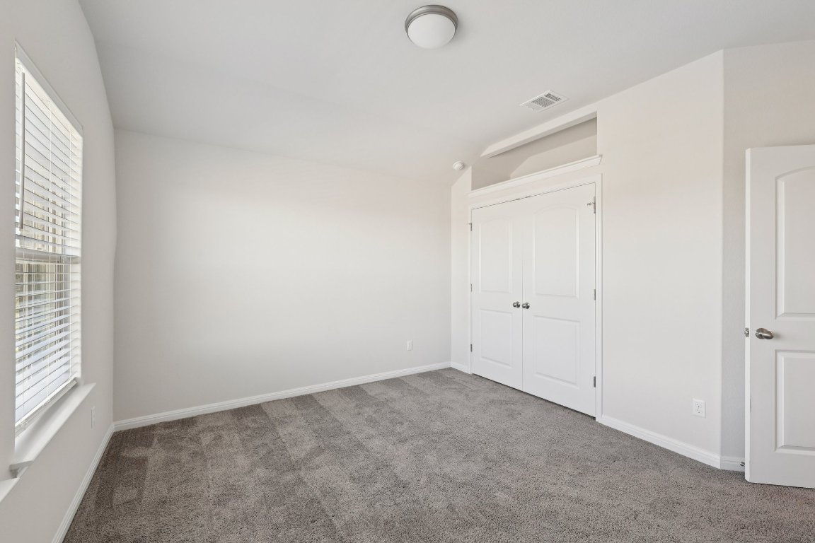 308 Castlefields Street Hutto, TX 78634 - Photo 26 of 31 an empty room with windows and closet