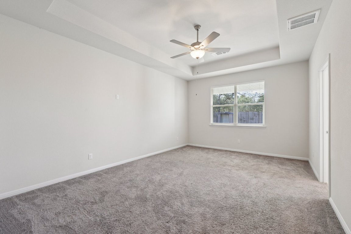 308 Castlefields Street Hutto, TX 78634 - Photo 5 of 31 an empty room with windows and fan