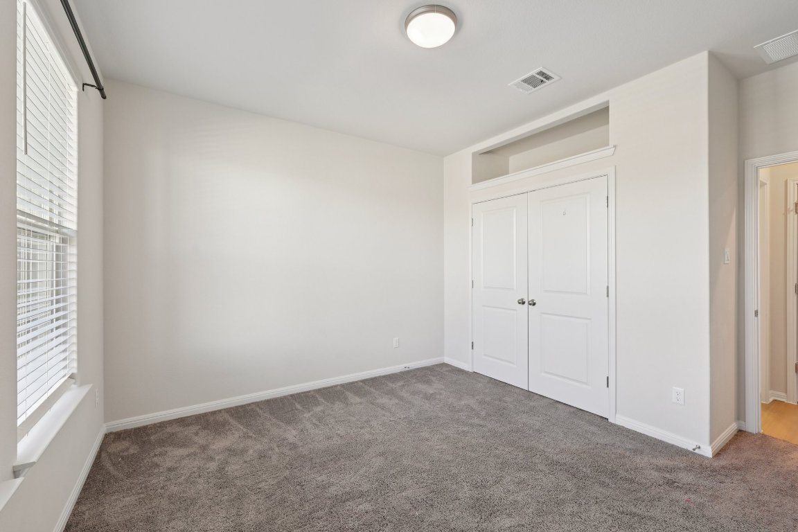 308 Castlefields Street Hutto, TX 78634 - Photo 9 of 31 a view of an empty room and a window