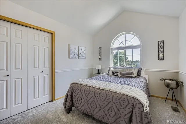 a spacious bedroom with a bed and a large window