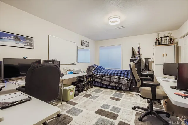 a bedroom with a workspace