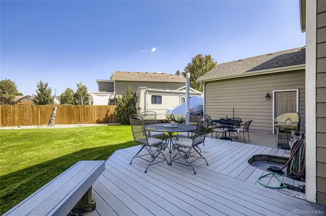 a view of a house with backyard porch and sitting area