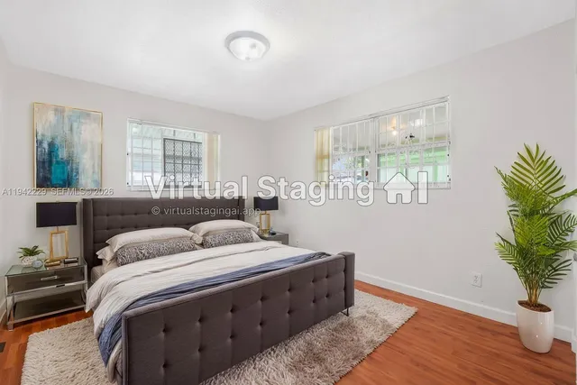 a bedroom with a bed and a potted plant