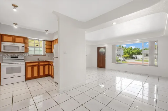 a kitchen with stainless steel appliances a stove a sink and a refrigerator