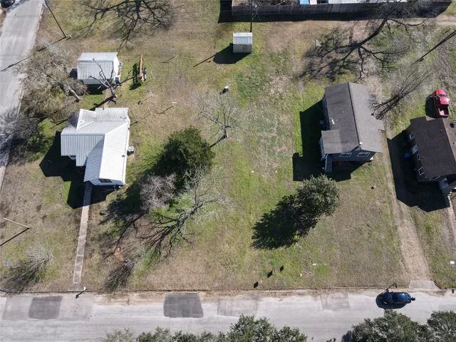 an aerial view of a house with a yard