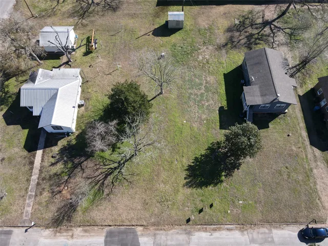 an aerial view of a house with a yard