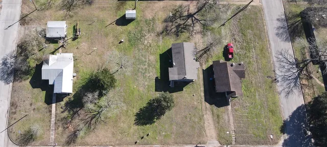 an aerial view of houses with trees