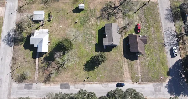 an aerial view of houses with trees