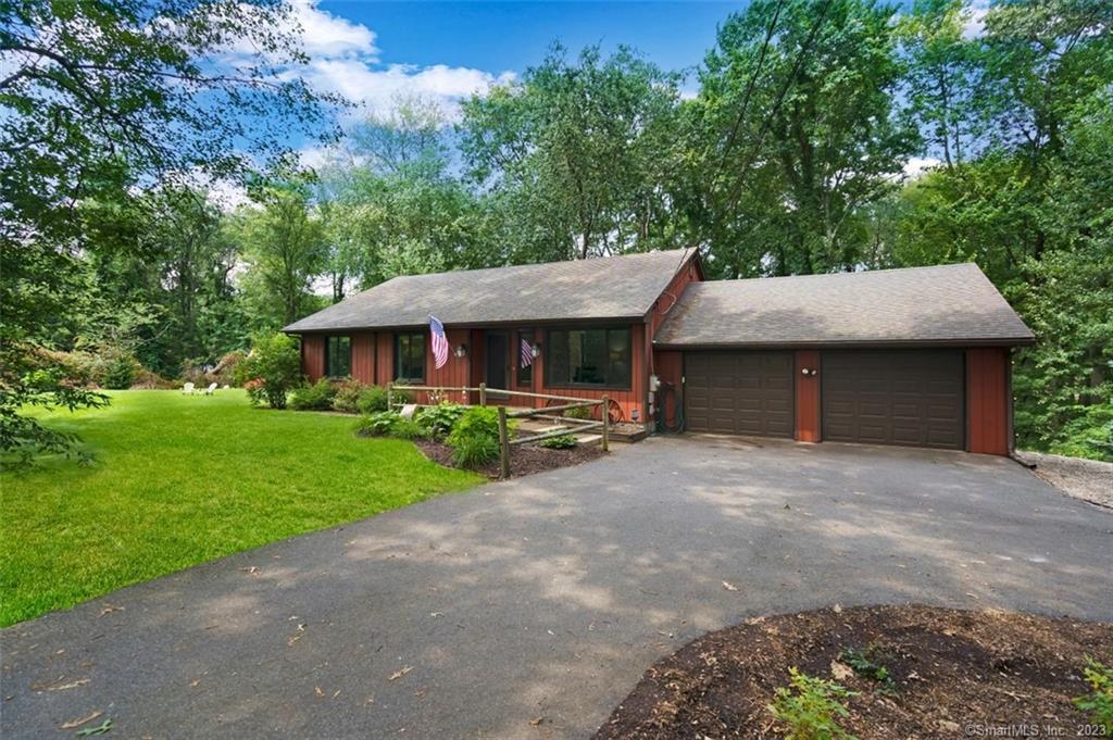 436 Old Post Road Tolland, CT 06084 - Photo 1 of 1 a patio with a table and chairs under an umbrella