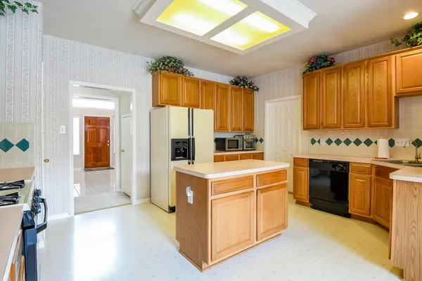 a kitchen with stainless steel appliances granite countertop a stove a refrigerator and a sink