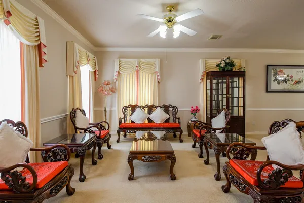 a living room with furniture and a chandelier