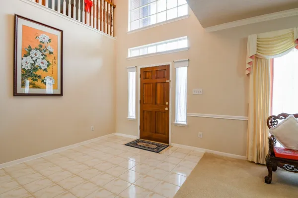 a view of a livingroom with wooden floor and a bathroom