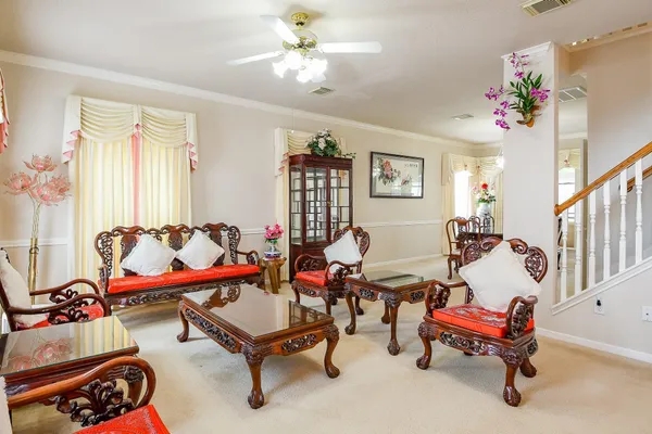 a living room with furniture and a chandelier