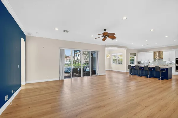 a view of a living room kitchen with furniture and wooden floor