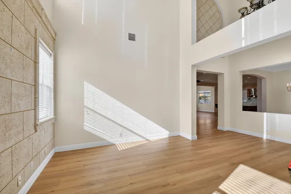 a view of a hallway with a livingroom and a bathroom with sink