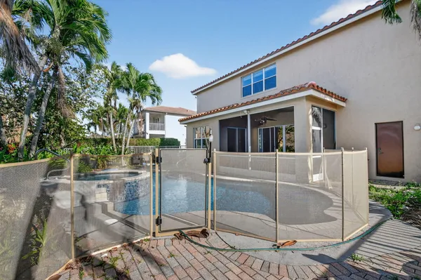 a front view of a house with a yard and potted plants