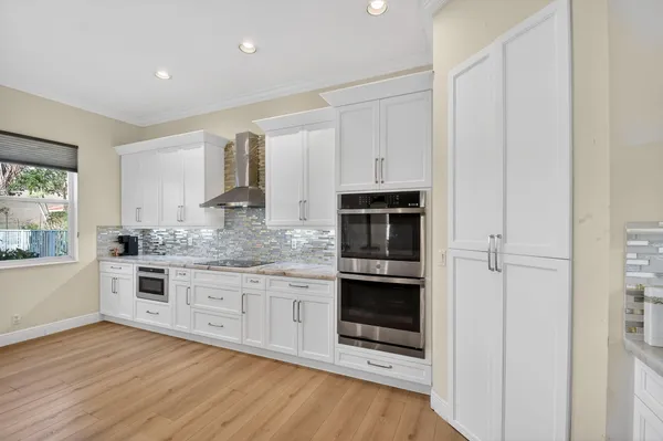 a spacious bathroom with a granite countertop sink and a large mirror