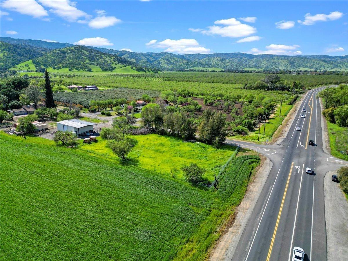 a view of a green field with sitting area