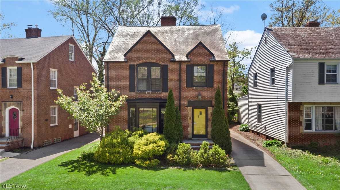 3806 Westwood Road University Heights, OH 44118 - Photo 1 of 41 Brick exterior with a peaked roofline, front bay window, and dark shutters