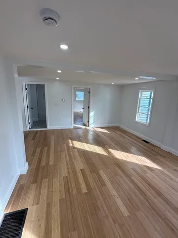 a bathroom with a granite countertop sink a toilet and a mirror