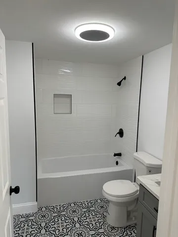 a view of a room with wooden floor and window