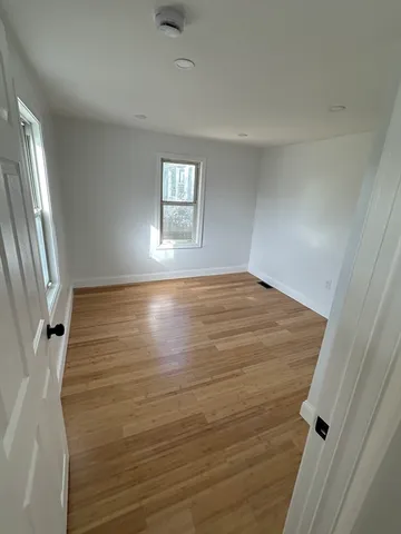 a view of a room with wooden floor
