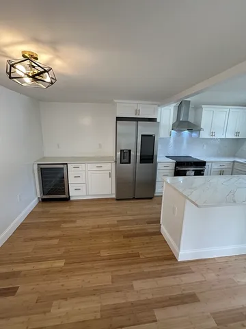 a view of a kitchen with a stove cabinets and wooden floor