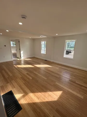 a view of wooden floor and windows in a room