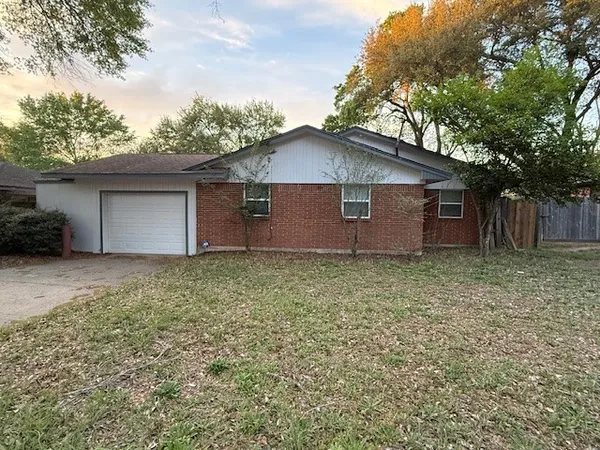 a front view of house with yard and trees