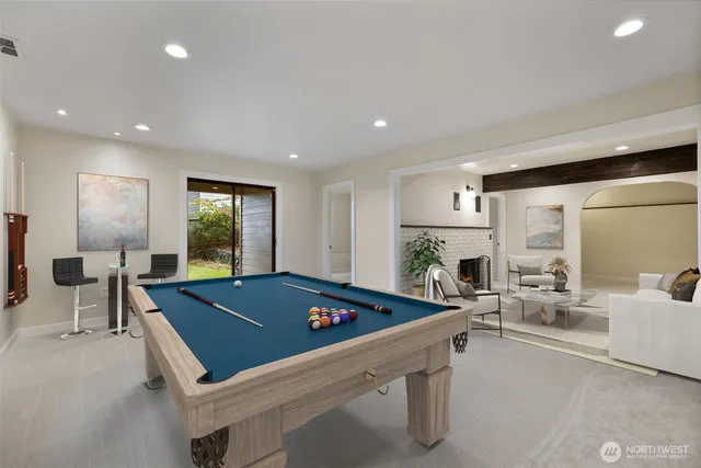 a room with furniture pool table and windows